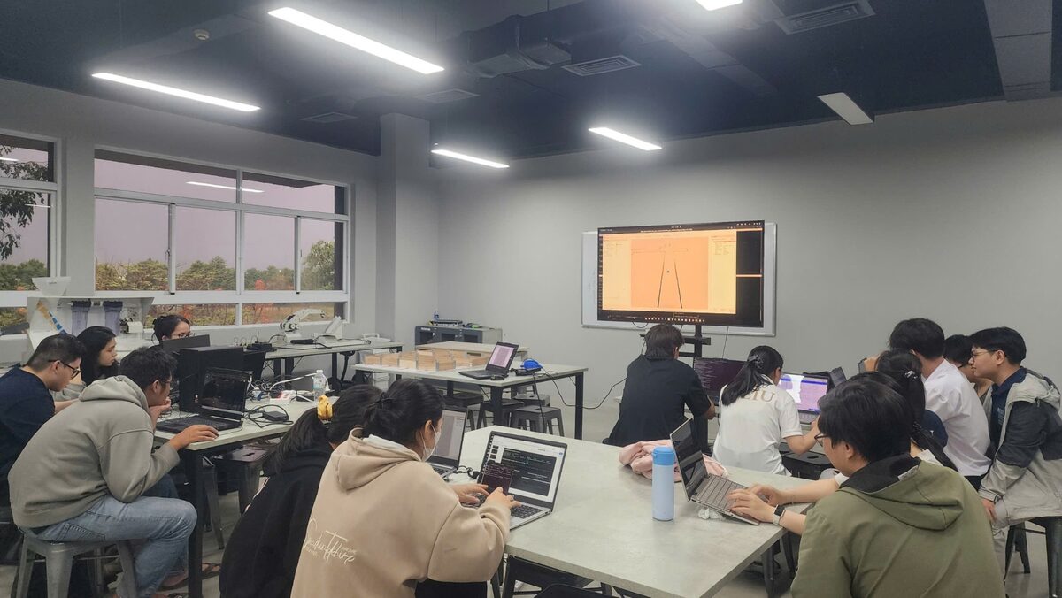 Students working on ROS 2 and the F1TENTH simulator during a workshop session