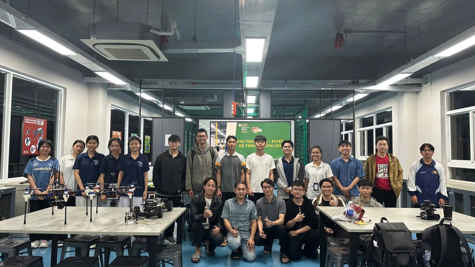 Students and robots after a workshop session at the EIU FabLab.
